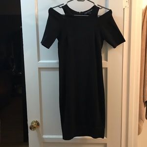 Knee length form-fitting black dress